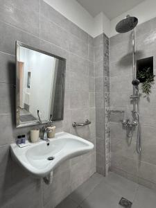 a bathroom with a white sink and a shower at Marvel Sea View 3 in Akrogiali +32 photos