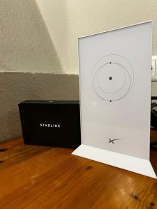 a white box with a cd in it on a wooden floor at Villa Helga by the Sea in Loutrá Elevtherón