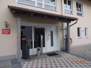 an entrance to a building with a glass door at Pension Alram Hof in Eggenfelden
