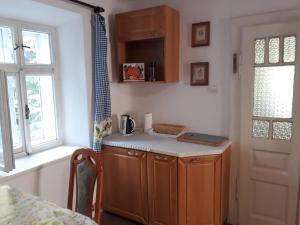 a small kitchen with a counter and a window at Chalupa Sehradický mlýn in Sehradice