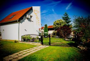 a white church with a gate and a fence at Apartments Dajčić in Varaždinske Toplice