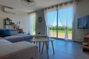 a living room with a couch and a table at Gîte au bord du lac - 4-10 pers - La Roche sur Yon in La Roche-sur-Yon