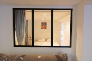 a mirror on the wall of a bedroom at L'entre deux in Entrelacs