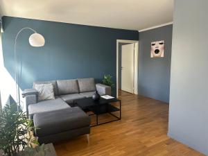 a living room with a couch and a table at Ålesund Urban - Spacious and luminous 100 m2 urban flat with 3 large bedrooms in Ålesund