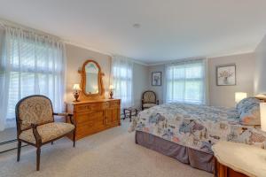 a bedroom with a bed and a dresser and a mirror at Water-View Beach House in Truro, Great for Groups! in Truro