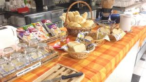 a table with baskets of bread and baskets of food at Hotel Zodiaco in Szekszárd