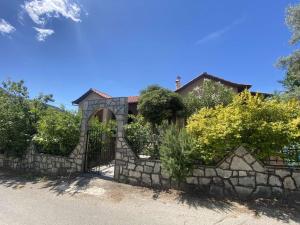 a stone fence in front of a house at Varagas Bliss in Sívros