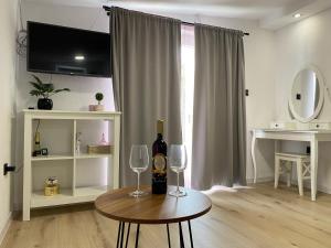a living room with a table with two wine glasses at Studio apartment Adrijana in Zagreb