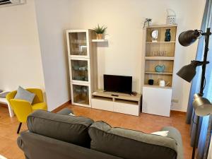 a living room with a couch and a television at Apartamento St Agustí - Centric in Mataró
