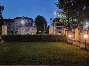 a park at night with buildings in the background at Statevi Guest Apartment in Velingrad