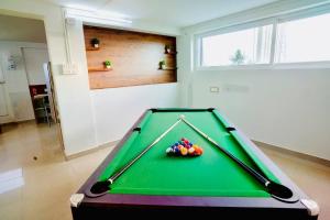 a pool table with balls on it in a room at Elite Enclave - Tellus - 2BHK - Luxury Serviced Apartments in Mysore