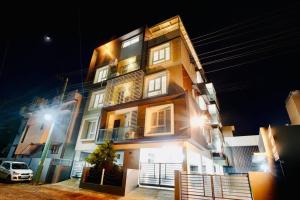 a building with a car parked in front of it at Elite Enclave - Tellus - 2BHK - Luxury Serviced Apartments in Mysore