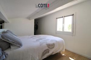 a bedroom with a large bed with a window at Villa Mozart - 6 couchages in Sausset-les-Pins