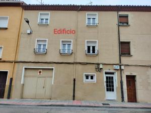 a building with a sign on the side of it at Casa Tito 2 in Santo Domingo de la Calzada