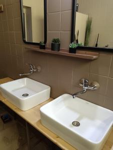 a bathroom with a white sink and a mirror at Apartman ClaRa in Štúrovo