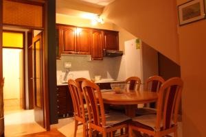 a kitchen with a table and chairs in a kitchen at Apartment Ivan in Račišće
