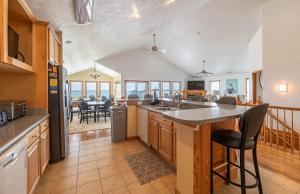 a kitchen with a counter and a dining room at Paradise Found in Nags Head