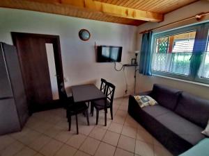 a living room with a couch and a table at Németh Apartmanház in Balatongyörök