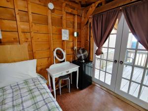 a bedroom with a bed and a desk with a mirror at Oakhill Pines Campground in Bridgewater +43 photos
