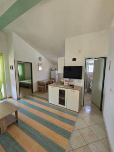 a large living room with a television and a table at Apartments Vodice Olga Matic in Vodice