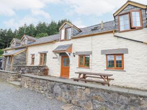 a house with a picnic table in front of it at Llys-y-Wennol in Betws-y-coed