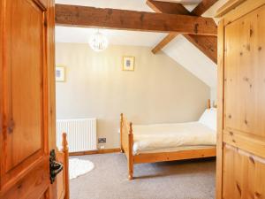 a bedroom with a bed in a attic at Llys-y-Wennol in Betws-y-coed