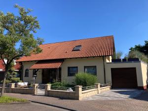 a house with an orange tiled roof at Ferienwohnung Finkenschlag in Speyer