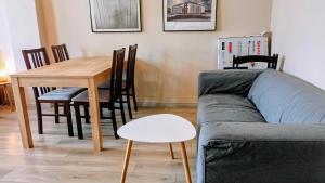 a living room with a couch and a table at Drzewna Apartamenty - Żeromskiego in Zielona Góra +38 photos