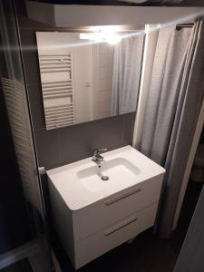 a bathroom with a white sink and a mirror at Cosy Paris in Paris