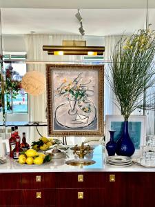 Una encimera de cocina con un cuadro de un jarrón. en Apollo Suite Rovinj, en Rovinj