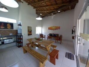 a living room with a wooden table and benches at Casa Sol in Prado