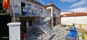a house with stairs and blue chairs on it at Villa Irena in Kruševo