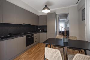 a kitchen with white cabinets and a table and chairs at NIMA Village in Paleros +25 photos