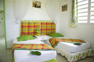two twin beds in a room with at Village de la Princesse in Saint-François