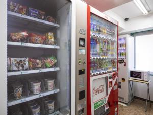 a cocacola soda vending machine in a room at Business Inn Norte Nakajima Park - Vacation STAY 08757v in Sapporo