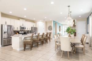 a kitchen and dining room with a table and chairs at Encore Resort and Water Park at Reunion by Rentyl in Kissimmee