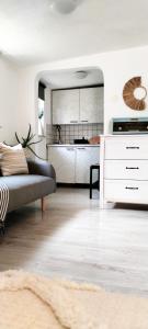 a living room with a couch and a kitchen at Apartment BoNo in Šmrika