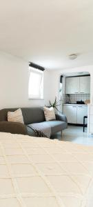 a living room with a couch and a bedroom at Apartment BoNo in Šmrika