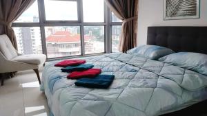 a bed with three pillows on it in a room with a window at Pool Haven Reservations in Kuala Lumpur +90 photos