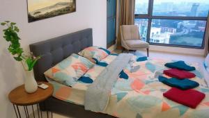 a bedroom with a bed with a table and a chair at Pool Haven Reservations in Kuala Lumpur