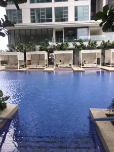 a large swimming pool in front of a building at Pool Haven Reservations in Kuala Lumpur