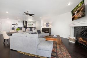 a living room with a couch and a fireplace at Hilltop Haven-5 Min to DT & UofA-Modern in Fayetteville