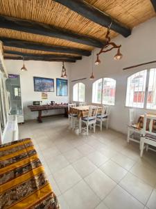 a room with a ping pong table and chairs at Hostal Tierra Andina Cafayate in Cafayate