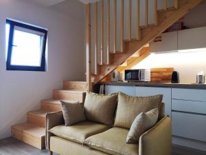 a living room with a couch and a staircase at Em Xisto - Casas de Montanha - Casa Xisto Nascente in Góis
