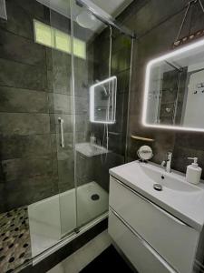 a bathroom with a glass shower and a sink at Charmant studio Horizon & Océan in Anglet