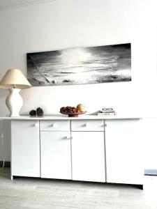 a white kitchen with a table with food on it at Charmant studio Horizon & Océan in Anglet