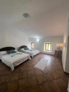 a bedroom with two beds and a tile floor at Vila Reževići in Budva +45 photos