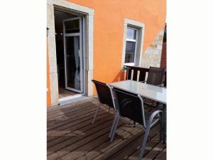 a table and chairs on a wooden deck at I "Old School" Comfortable holiday residence in Reinhardtsdorf +5 photos