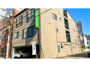 a building with a green sign on the side of it at Nagomi no yado Origami - Vacation STAY 80226v in Nagasaki