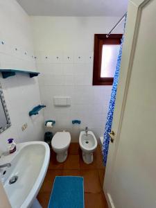 a bathroom with a white toilet and a sink at LE TERRAZZE Porto Rotondo in Porto Rotondo
